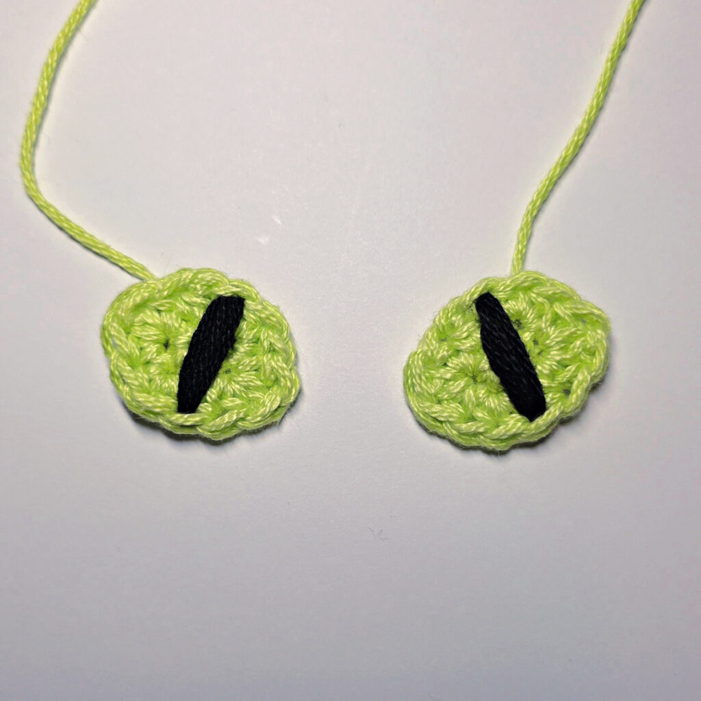 Eyes of a crochet black cat.