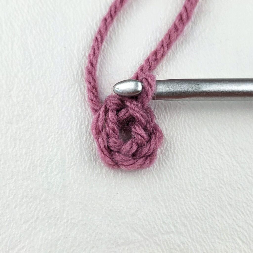 Making a block stitch granny square with a crochet hook.