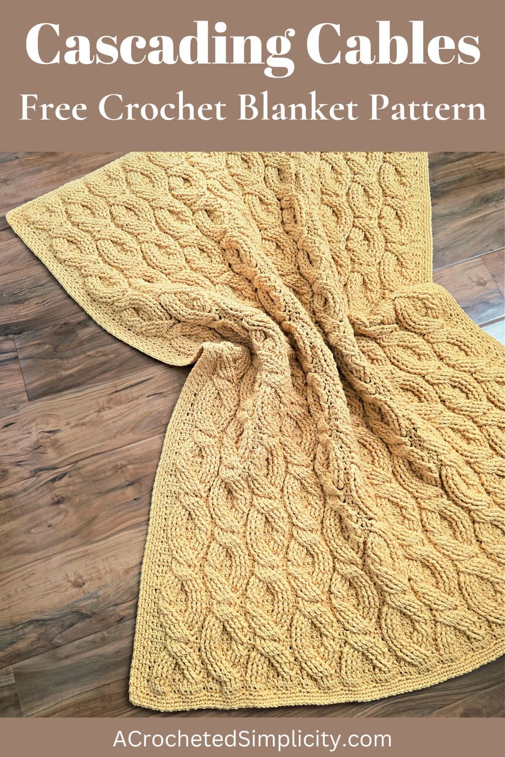 Yellow crochet cable blanket spread on the floor.