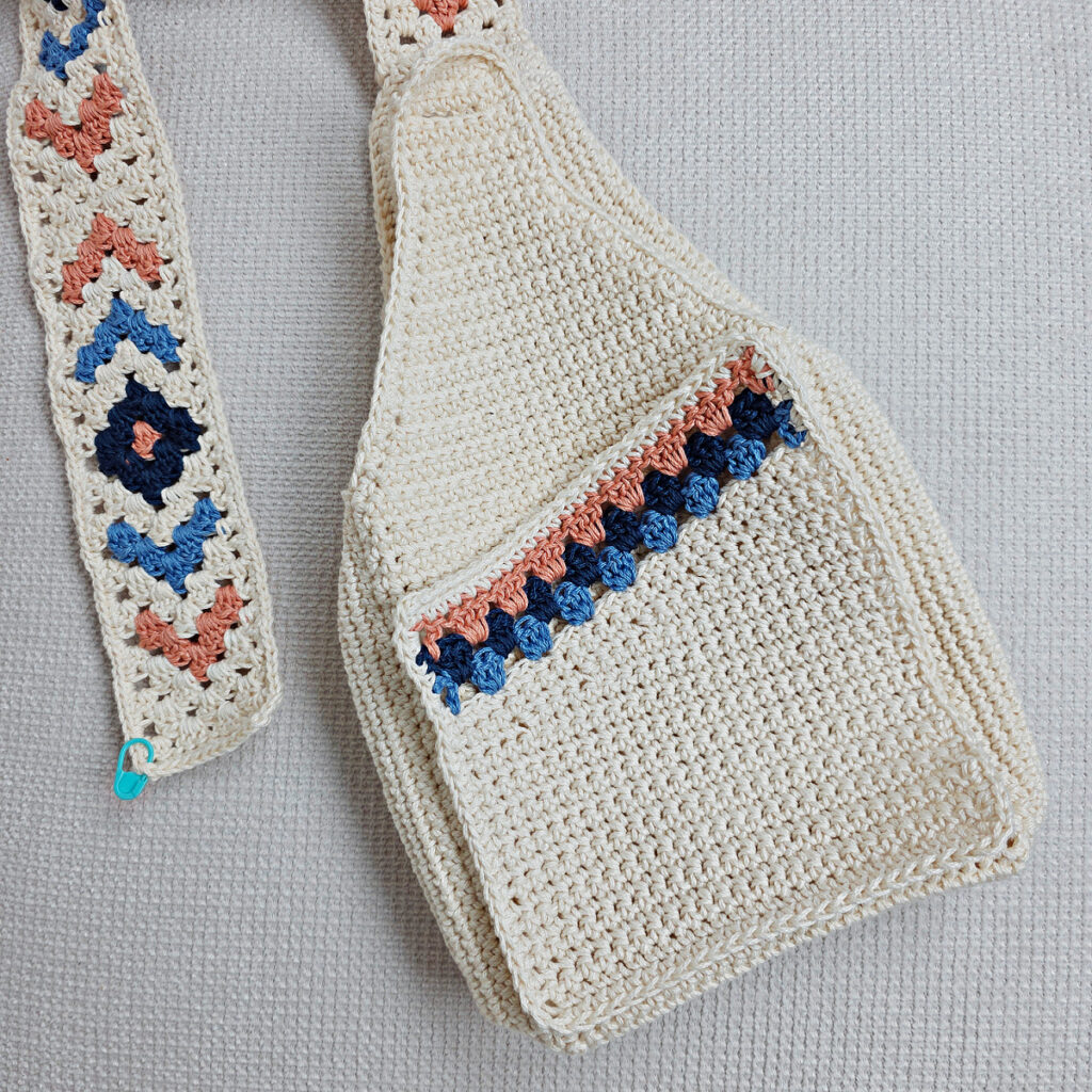 Completed body of a crochet boho sling bag.