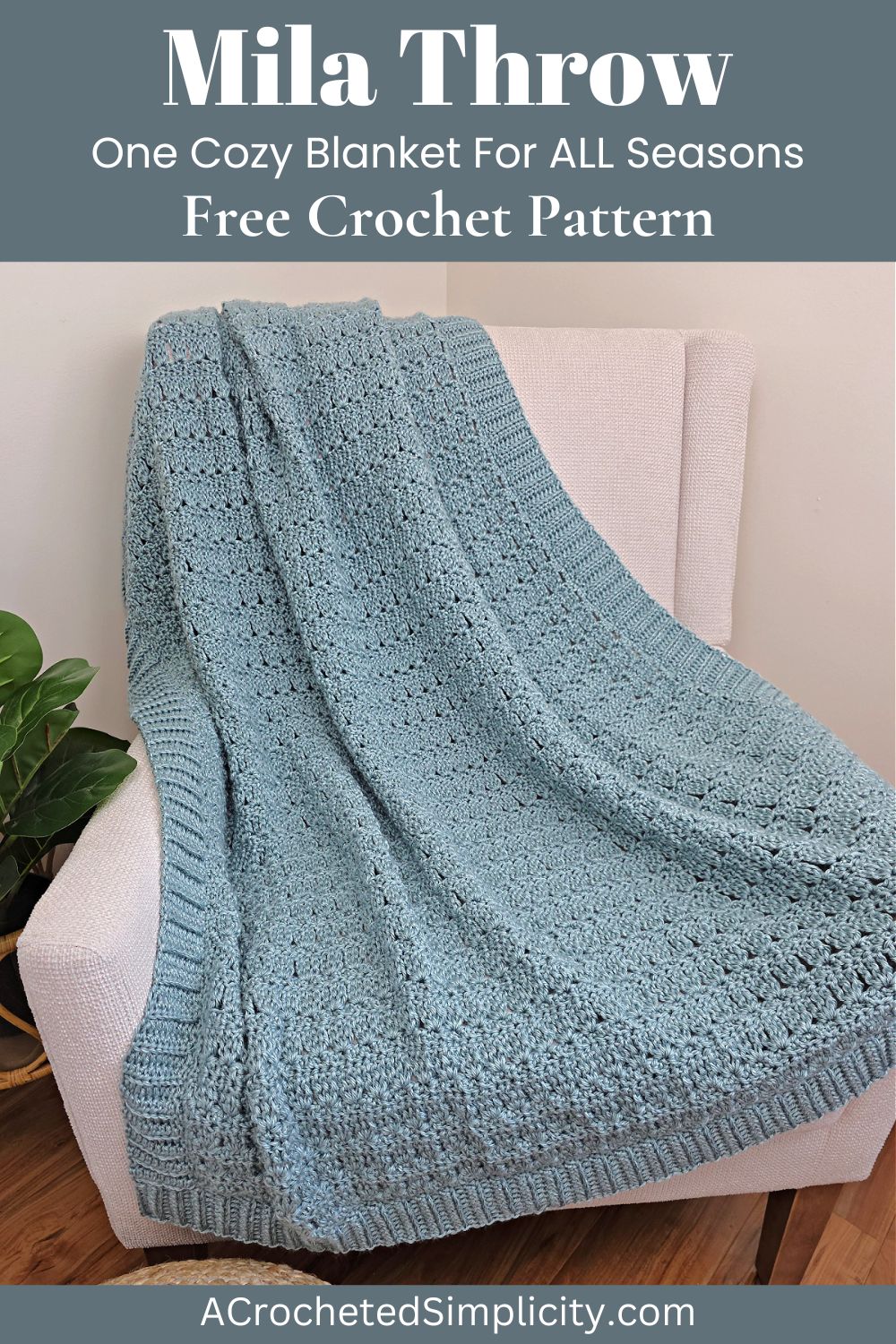 Blue crochet throw blanket on a white sofa with a plant next to it.