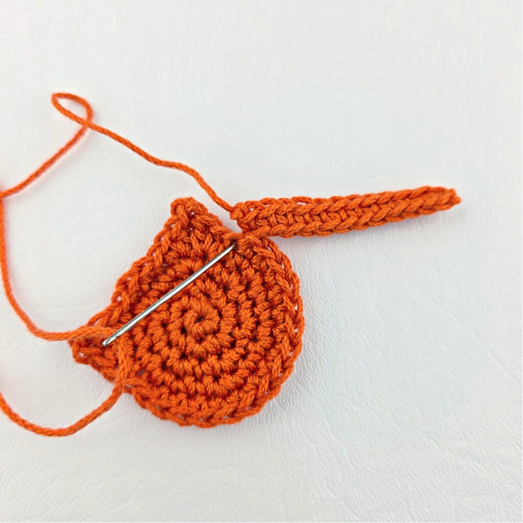 Making an orange cat crochet bookmark.