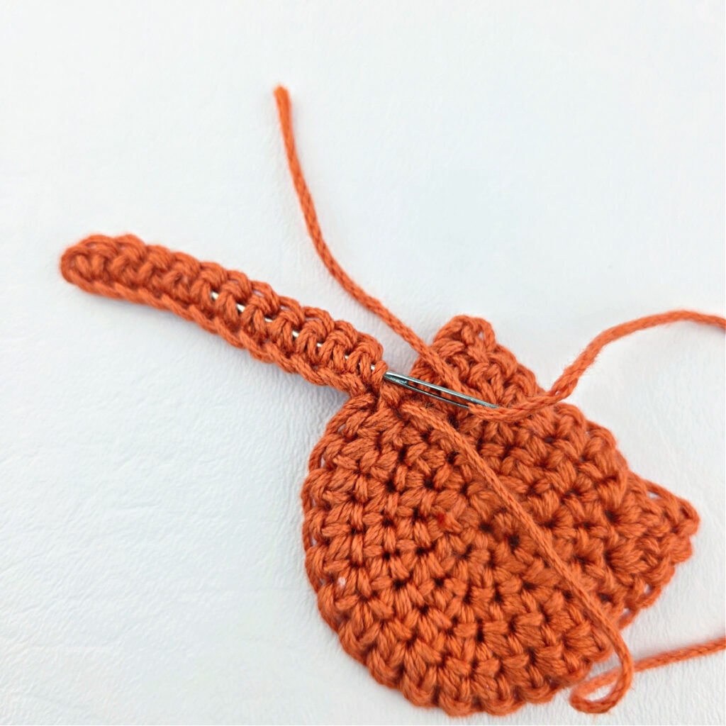 Making an orange cat crochet bookmark.