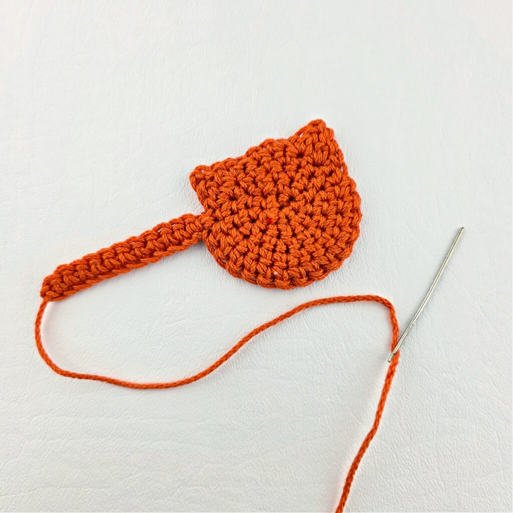 Making an orange cat crochet bookmark.