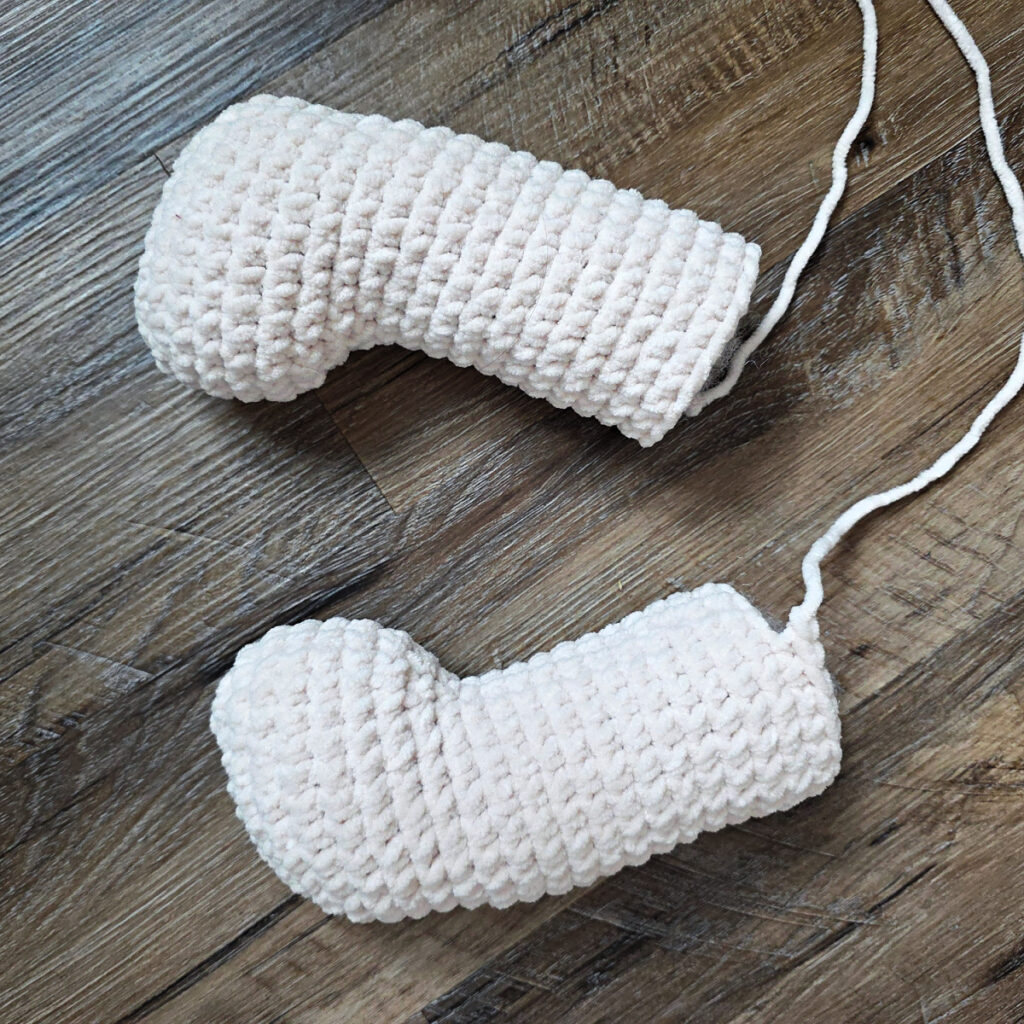 Legs of a crochet dog amigurumi.