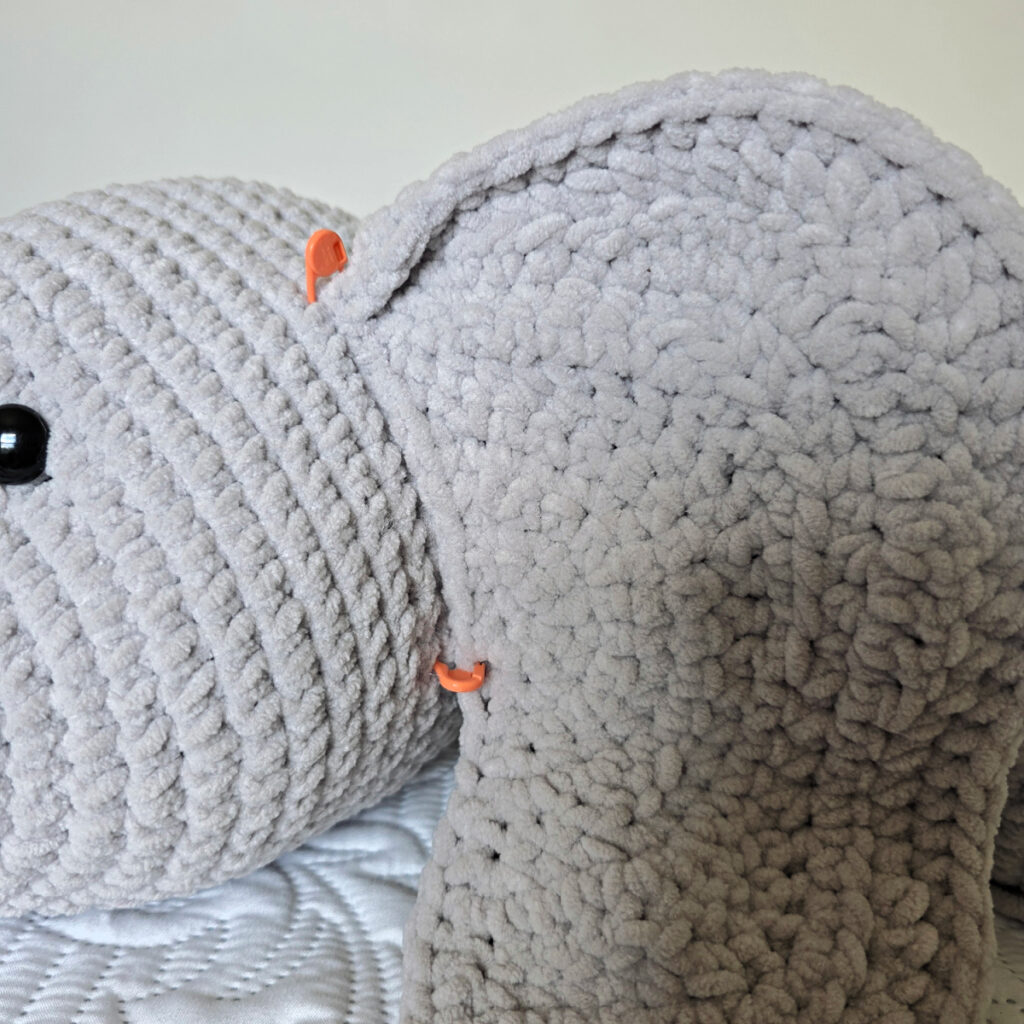 A gray crochet elephant head in progress.