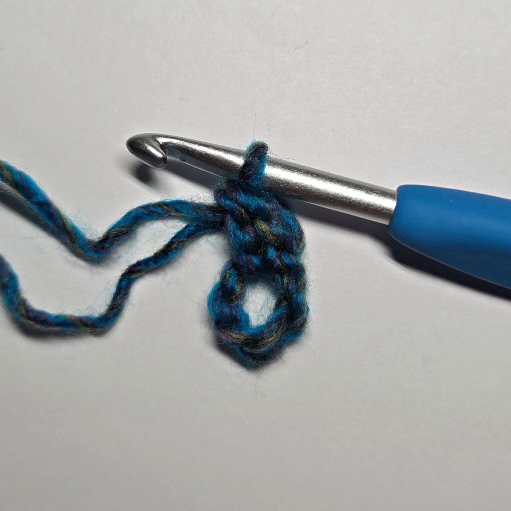 How to work a crochet floral square with a blue crochet hook.
