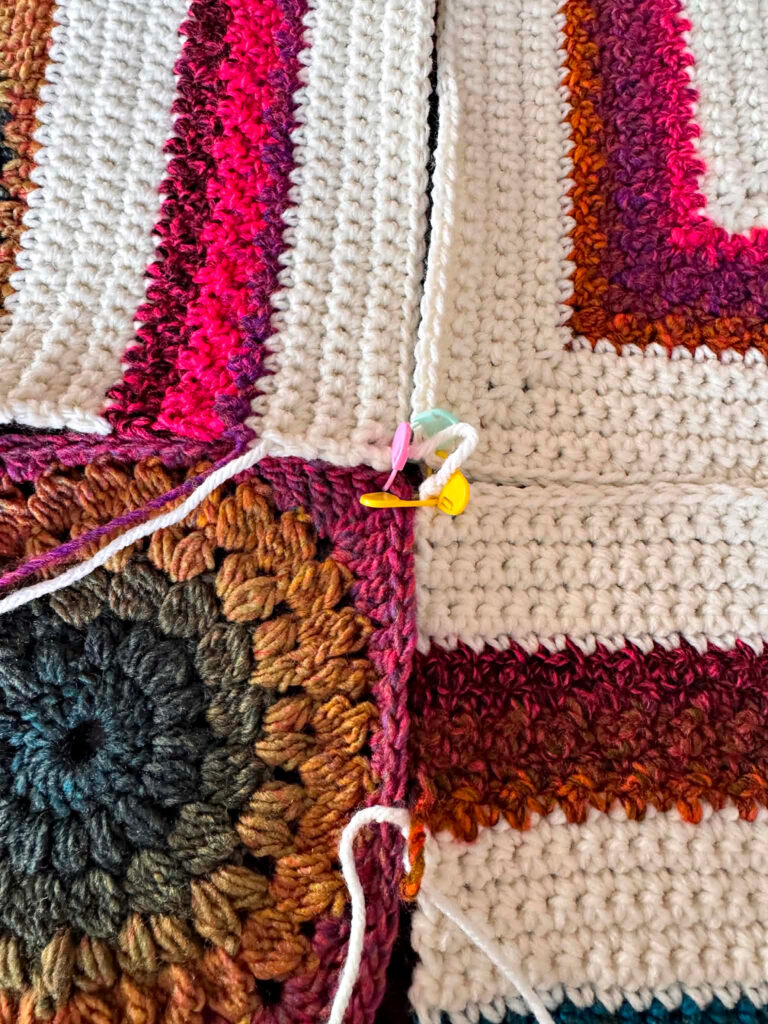 Seaming together a modern crochet blanket.