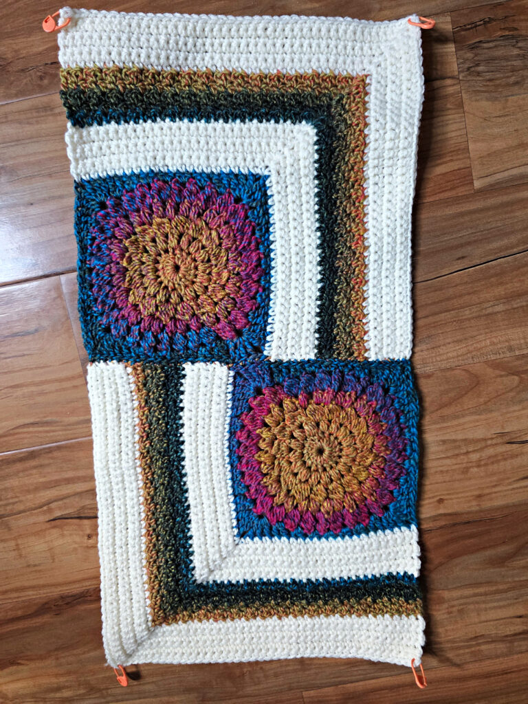Seaming together a modern crochet blanket.