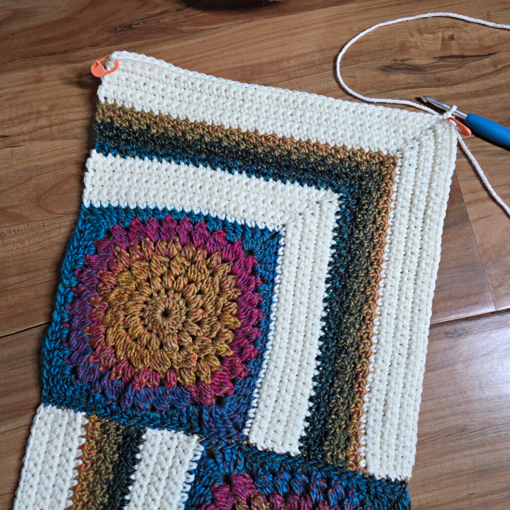 Seaming together a modern crochet blanket.