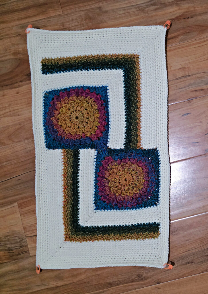 Seaming together a modern crochet blanket.