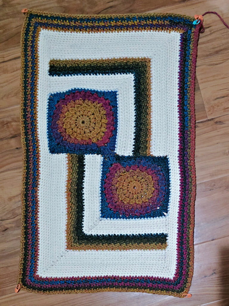 Seaming together a modern crochet blanket.