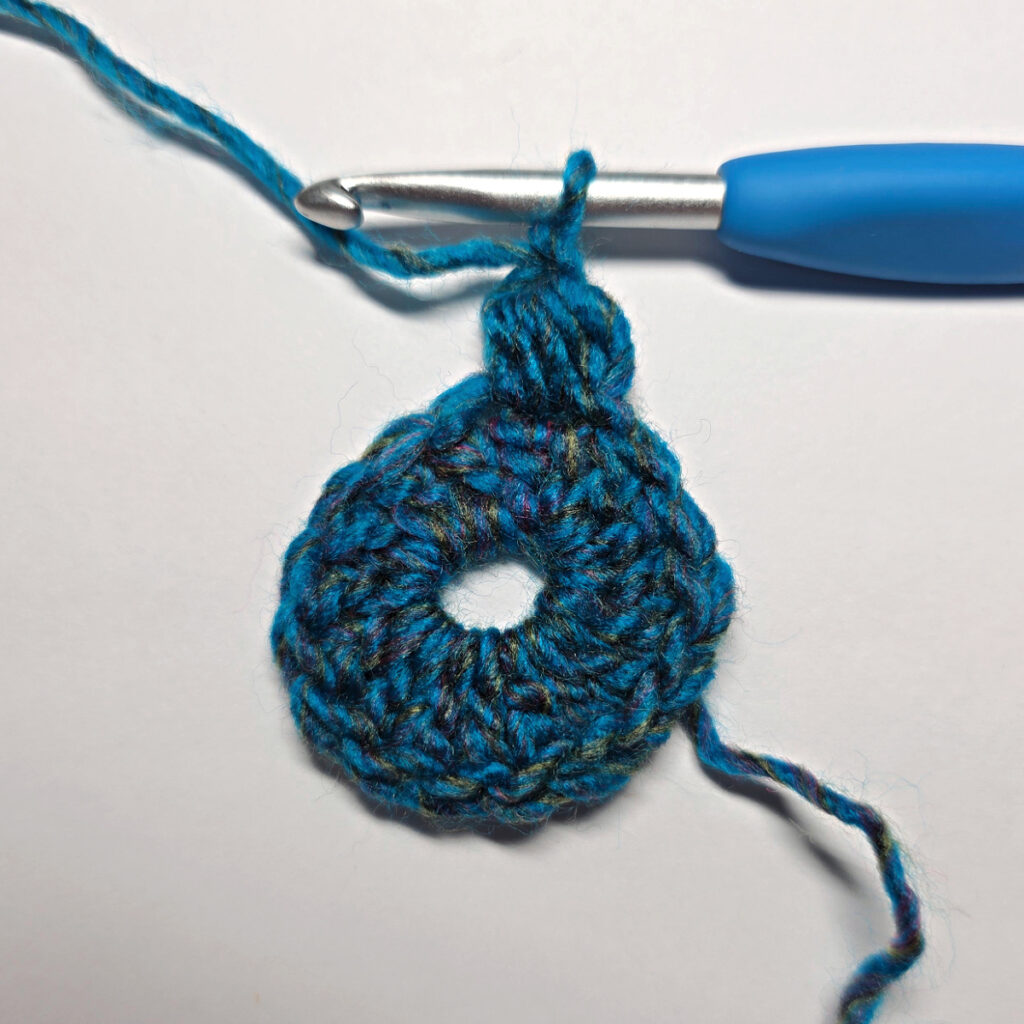 How to work a crochet floral square with a blue crochet hook.