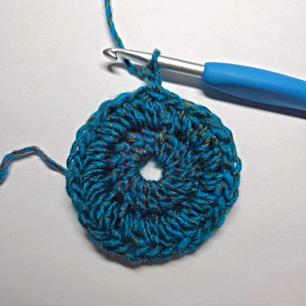How to work a crochet floral square with a blue crochet hook.