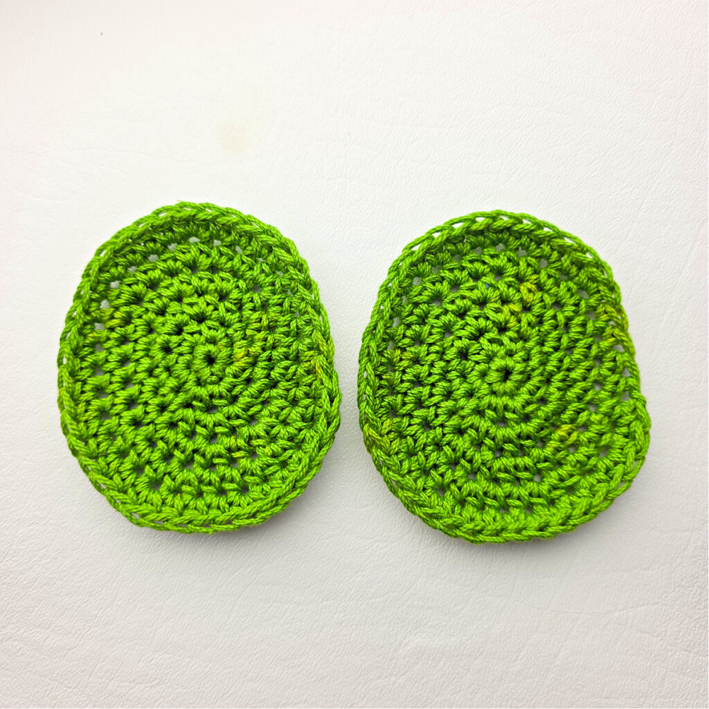 Two green crochet circles against a white background.
