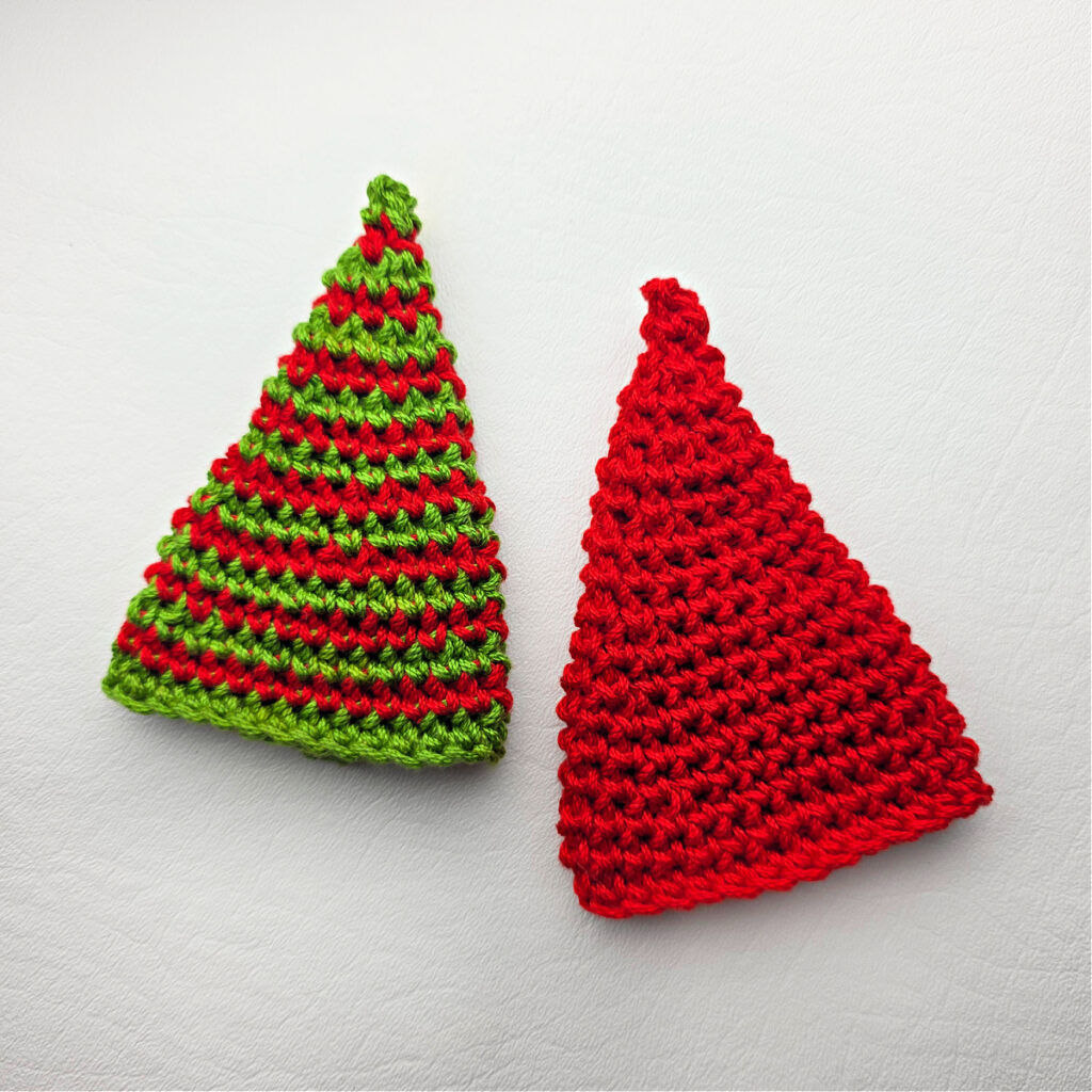 Two crochet santa hats against a white background.