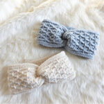 A gray crochet ear warmer and white crochet ear warmer against a white background.