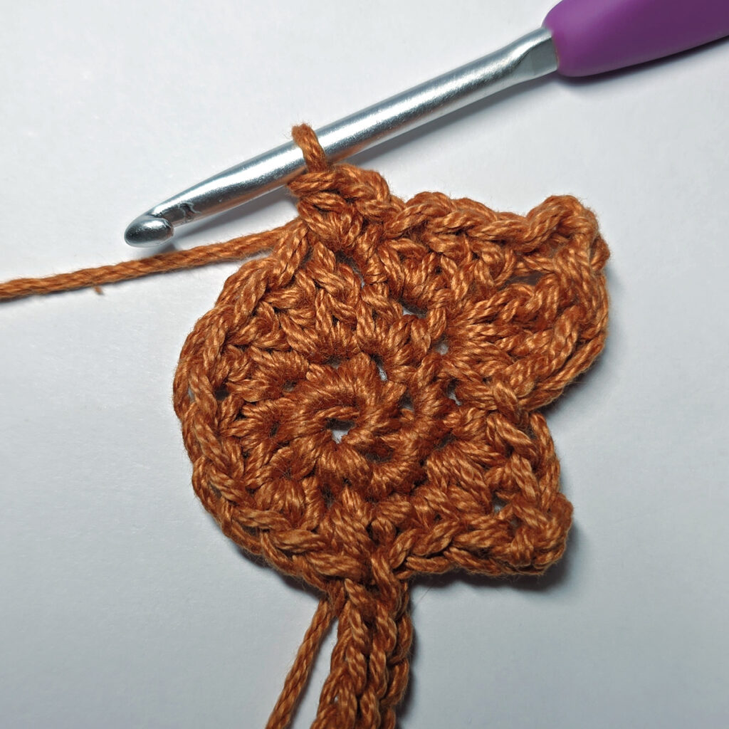 Making a crochet maple leaf.