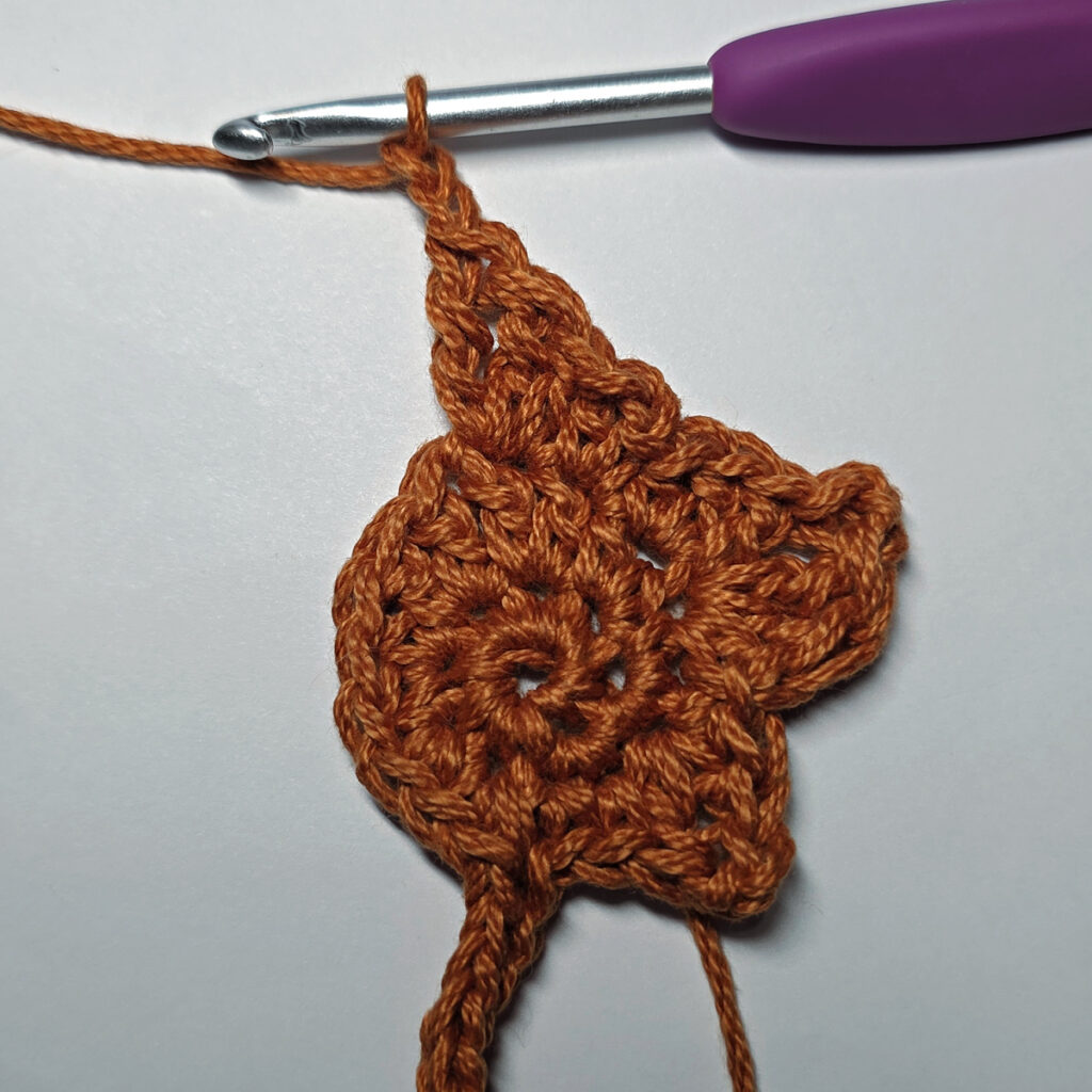 Making a crochet maple leaf.