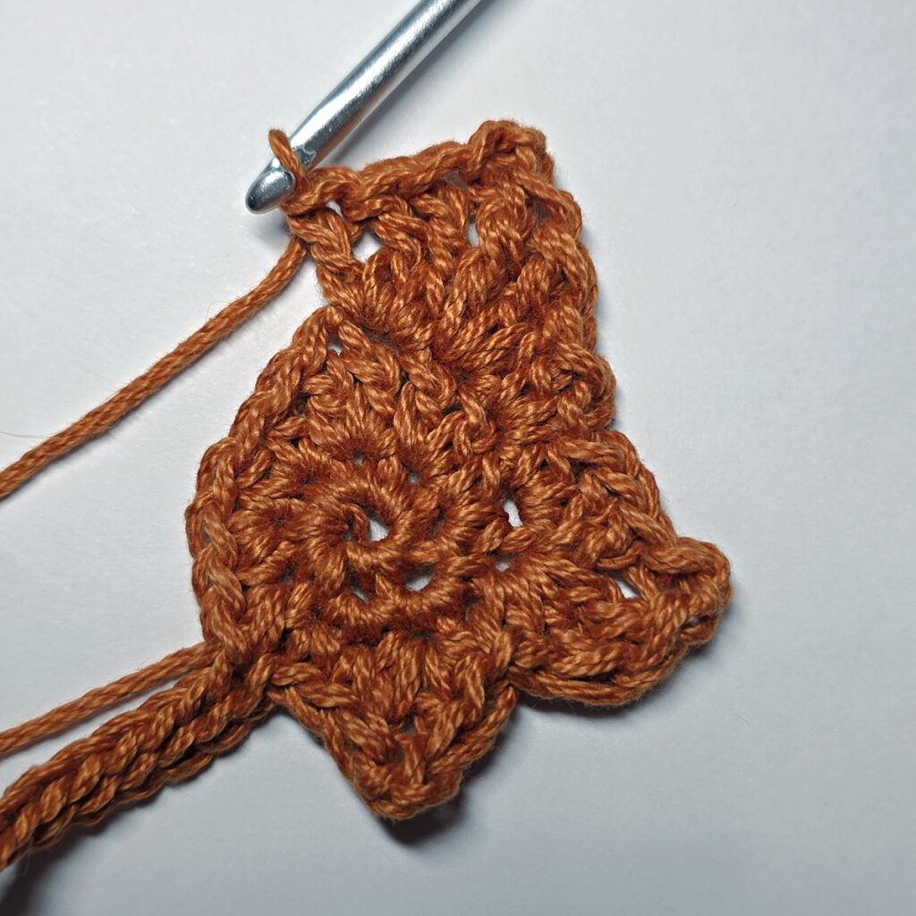 Making a crochet maple leaf.