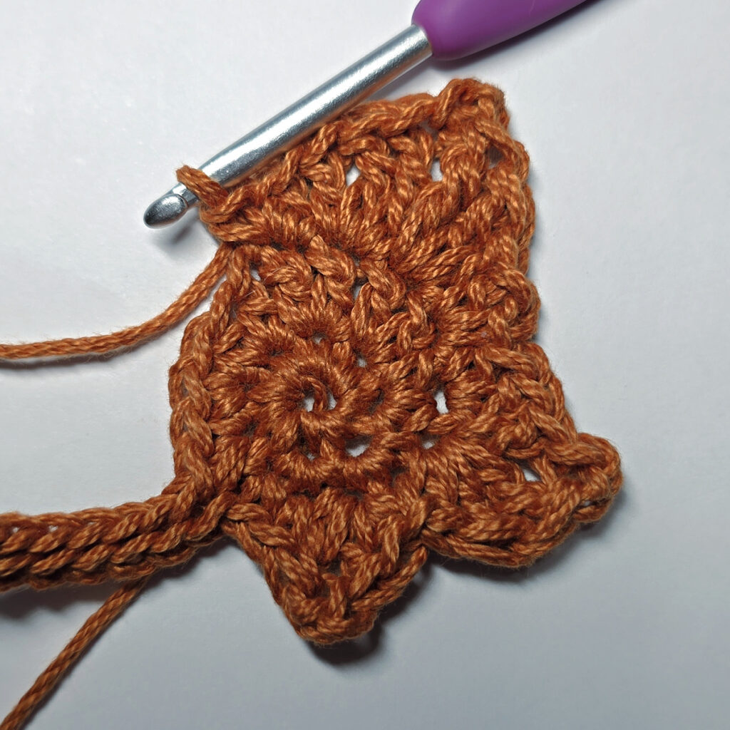 Making a crochet maple leaf.