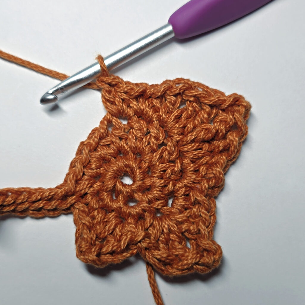 Making a crochet maple leaf.