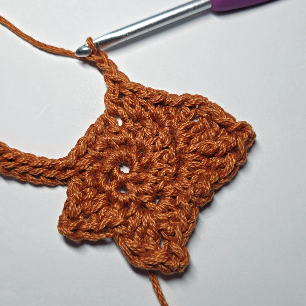 Making a crochet maple leaf.