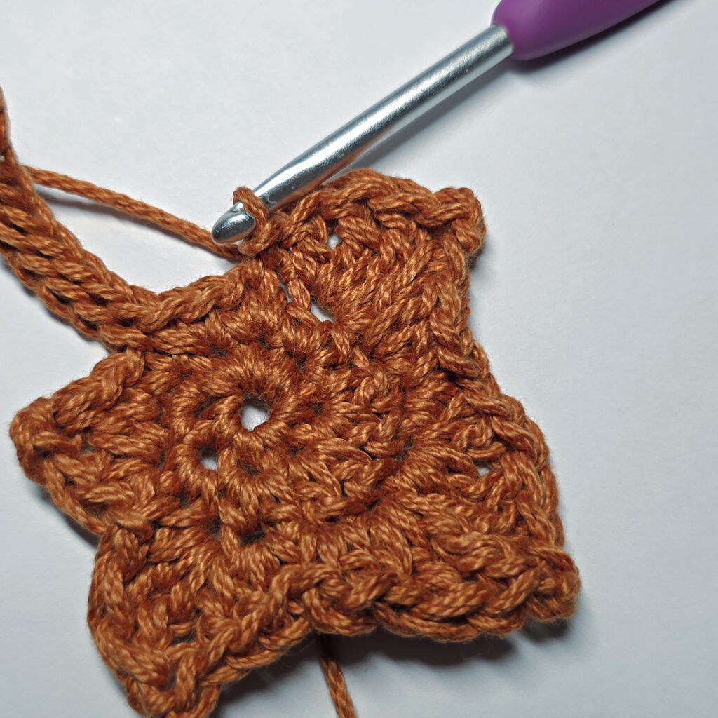 Making a crochet maple leaf.