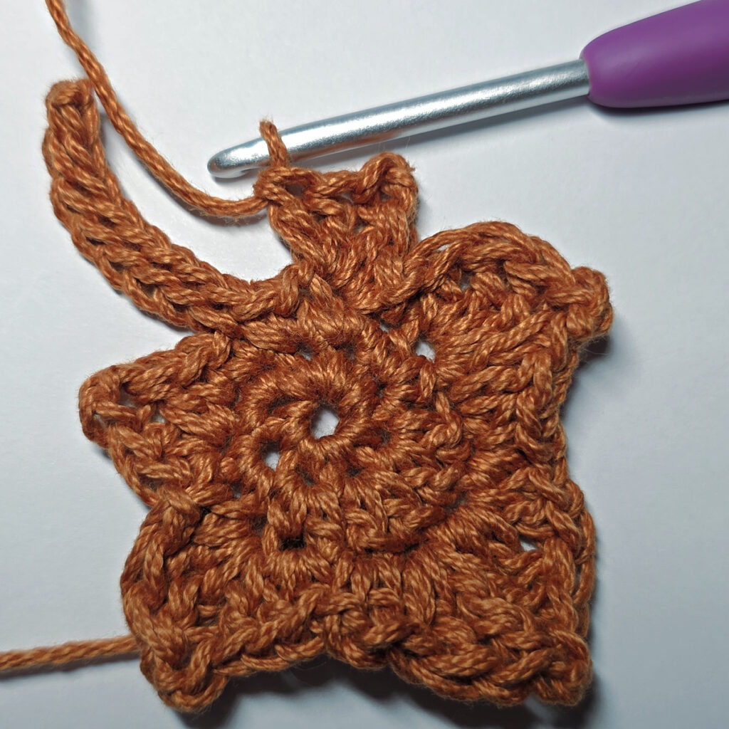 Making a crochet maple leaf.
