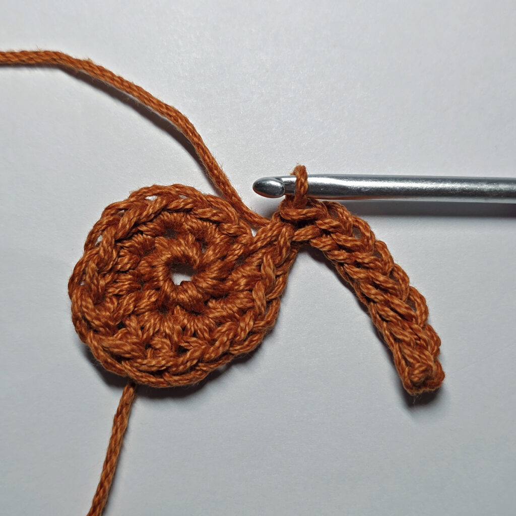 Making a crochet maple leaf.