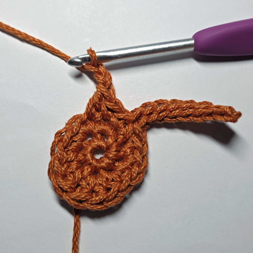 Making a crochet maple leaf.