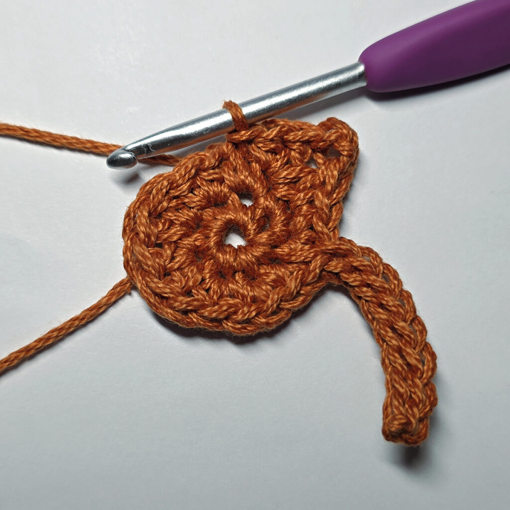 Making a crochet maple leaf.