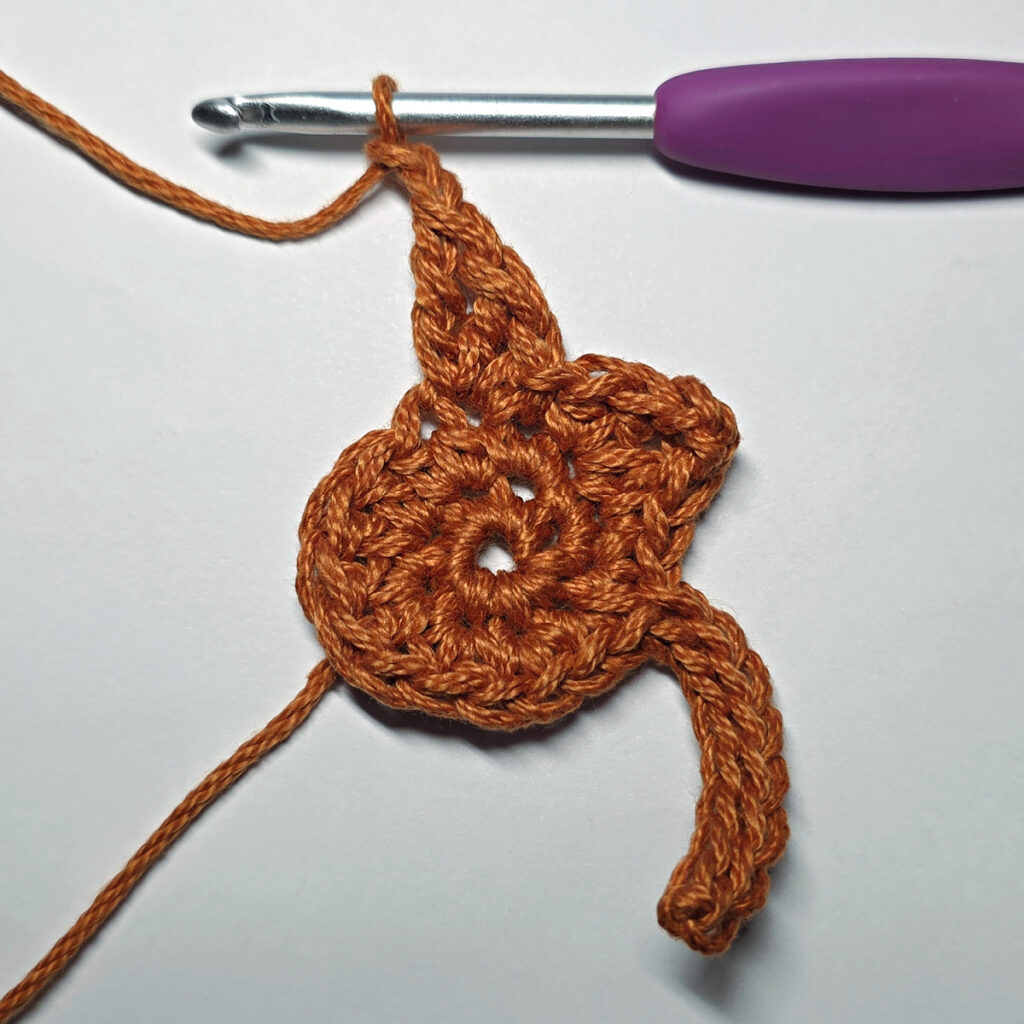 Making a crochet maple leaf.