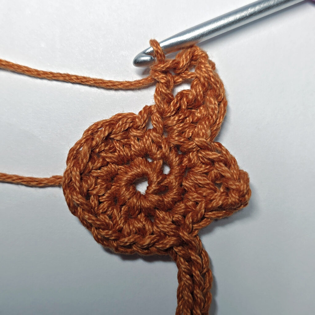 Making a crochet maple leaf.