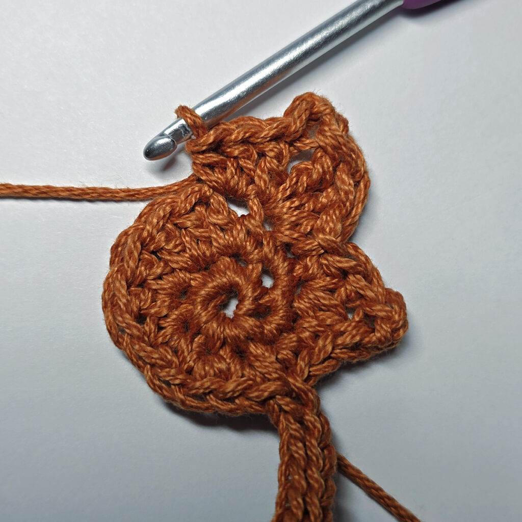 Making a crochet maple leaf.