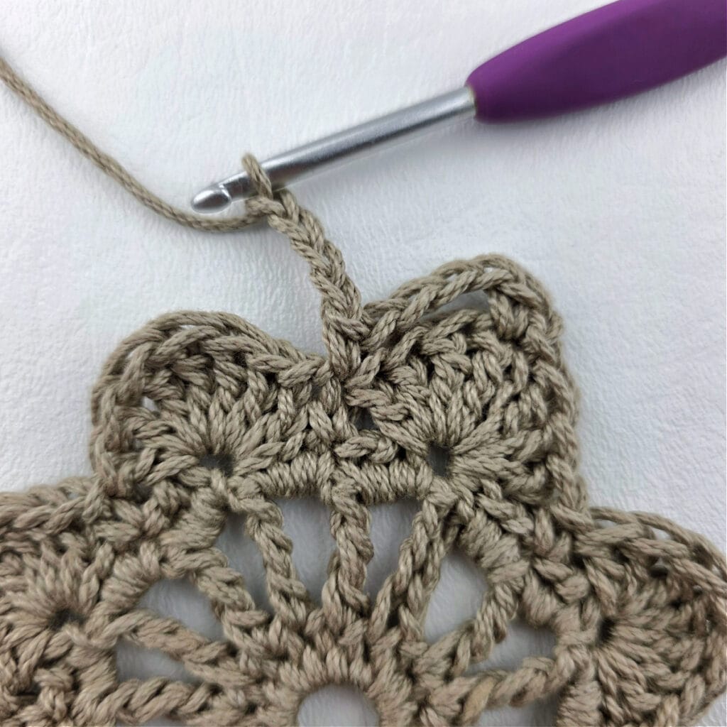 Round 5 of a crochet granny square motif.