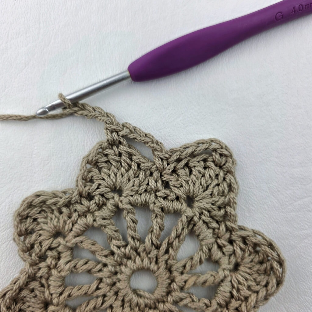 Round 5 of a crochet granny square motif.