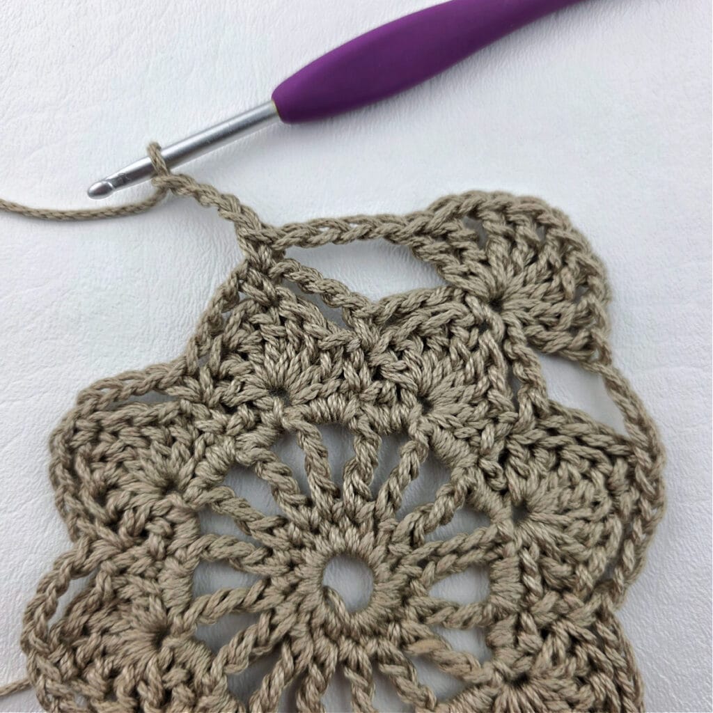 Round 6 of a crochet granny square motif.