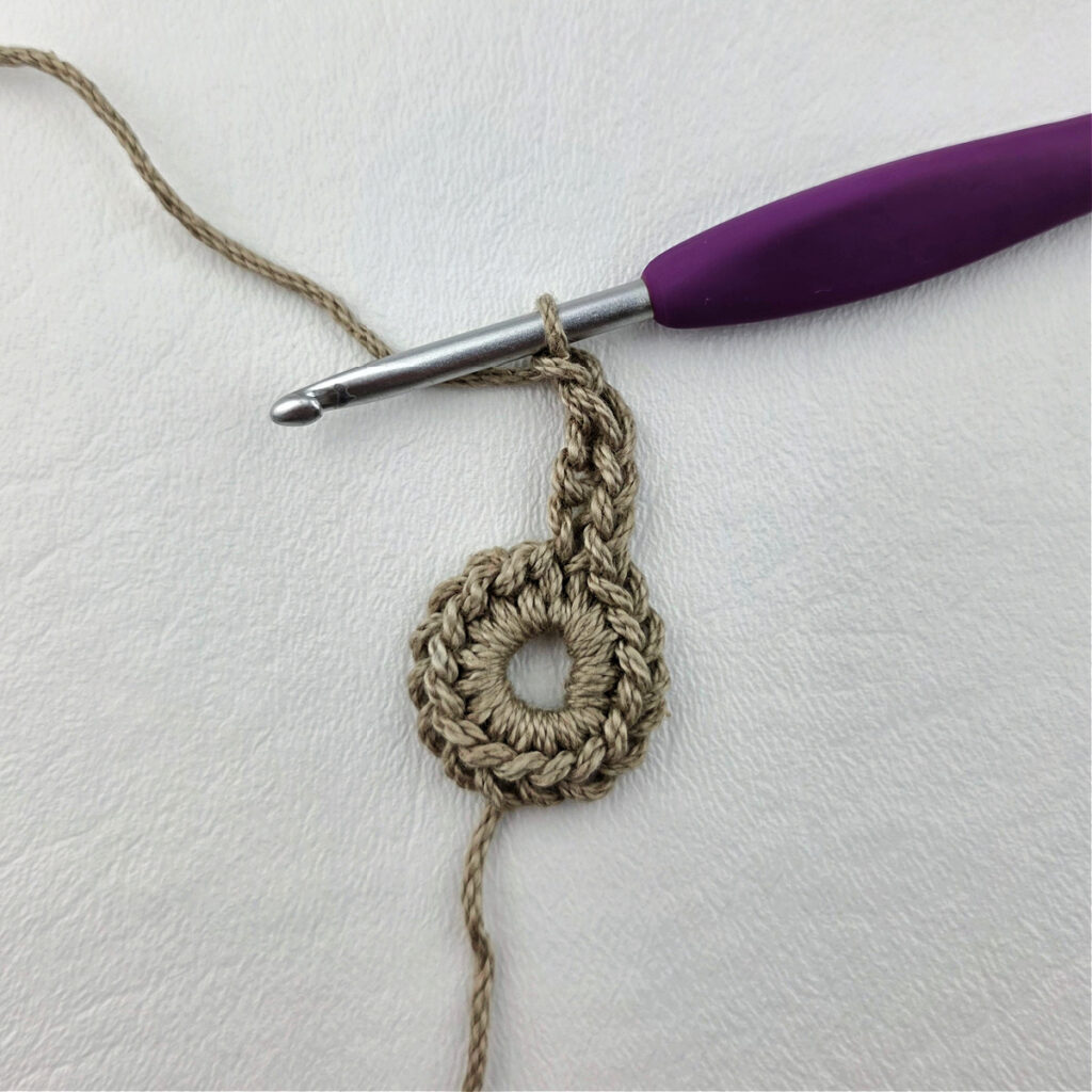Round 2 of a crochet granny square motif.