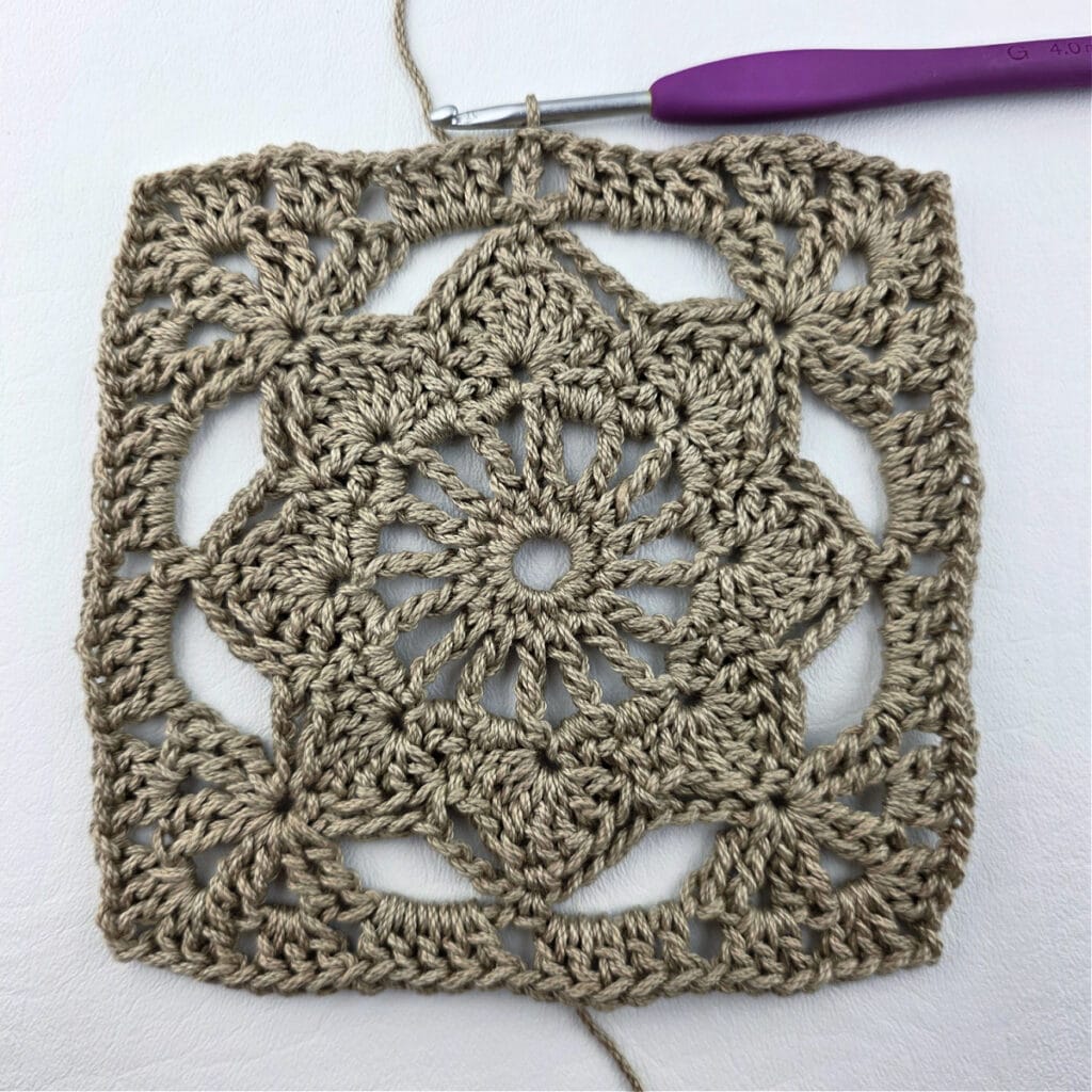 A completed crochet granny square motif.