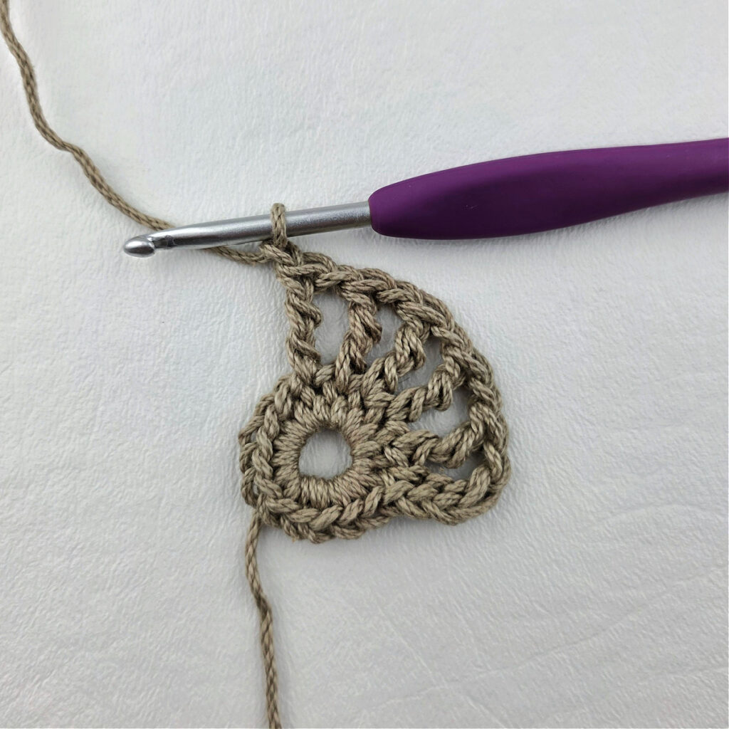 Round 2 of a crochet granny square motif.