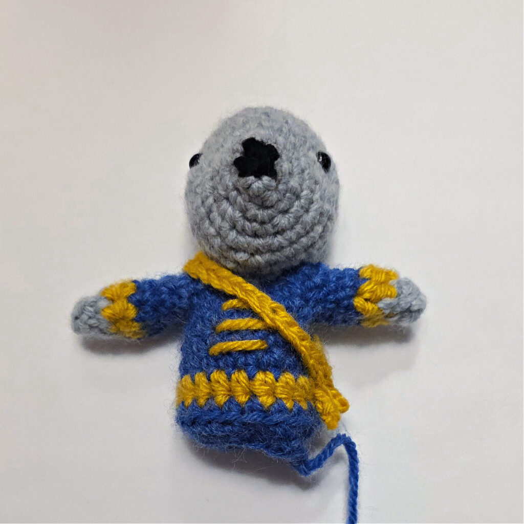 The gold sash is attached to the mouse's shoulder.