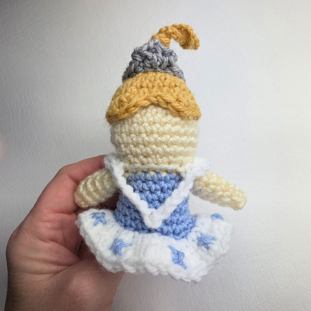 A crochet nutcracker snow queen ornament ready for facial features to be added.