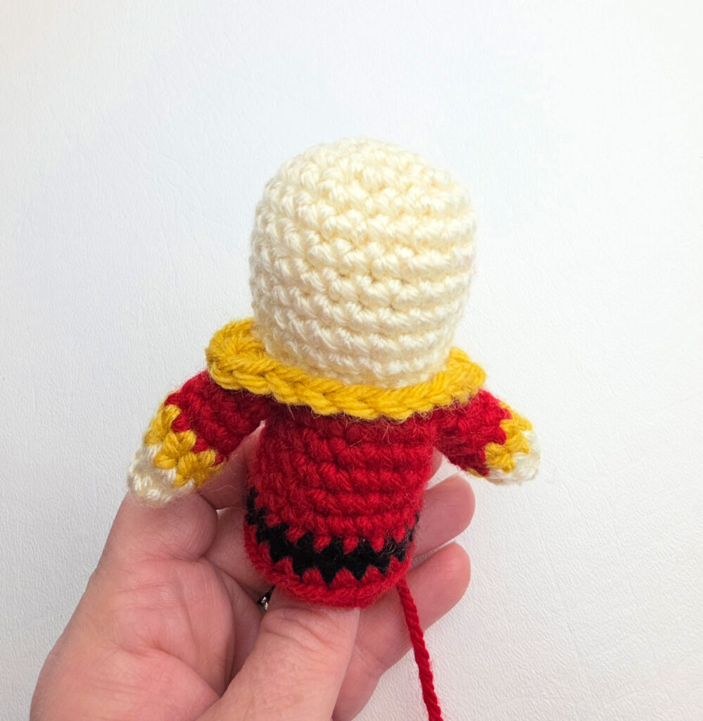 A top view of the gold collar added to the crochet nutcracker.