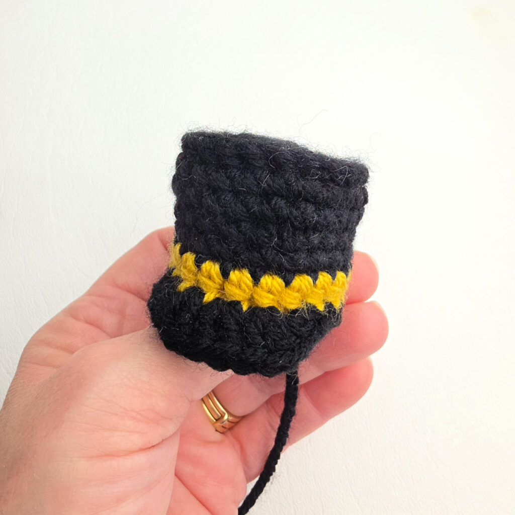 A small nutcracker's hat held by a hand.