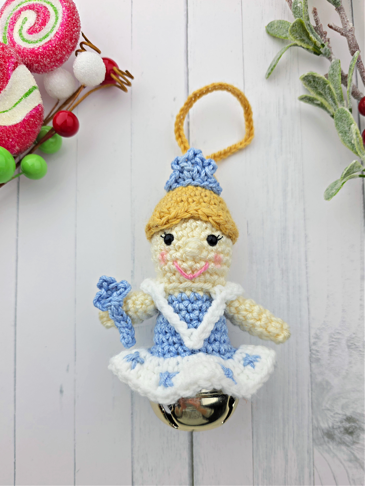 Nutcracker Snow Queen Crochet Ornament with blonde hair and blue dress on white background.