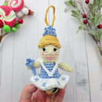 Nutcracker Snow Queen Crochet Ornament with blonde hair and blue tiara on white background.