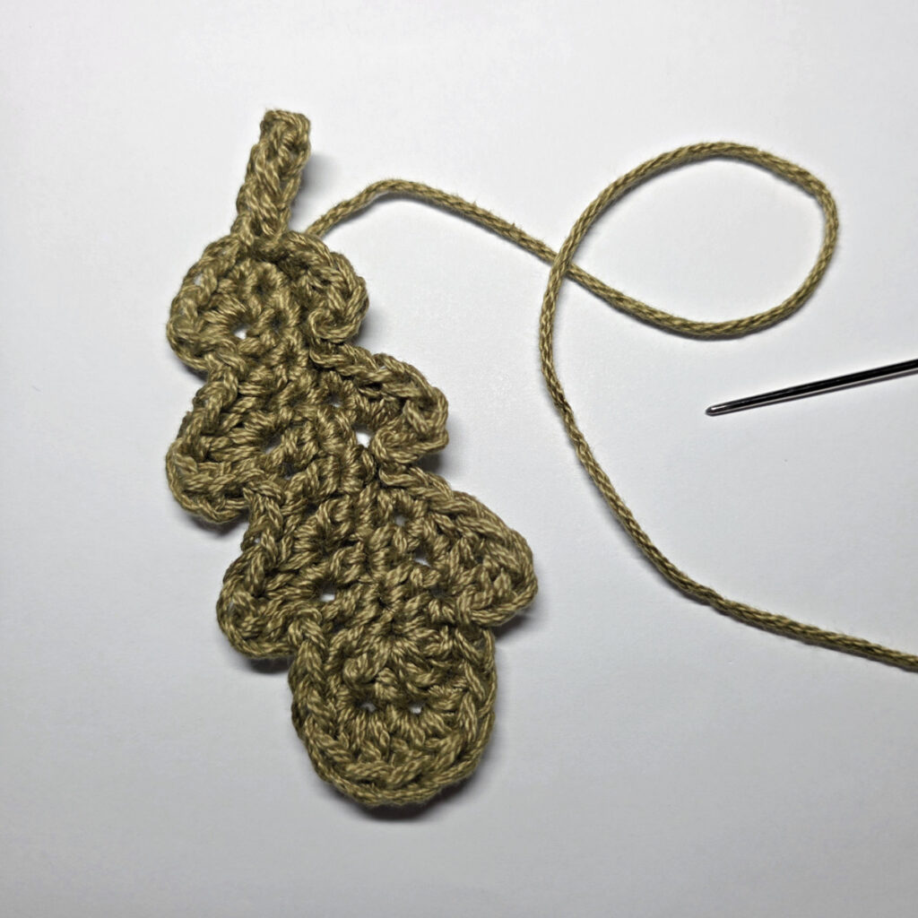 A completed crochet oak leaf.