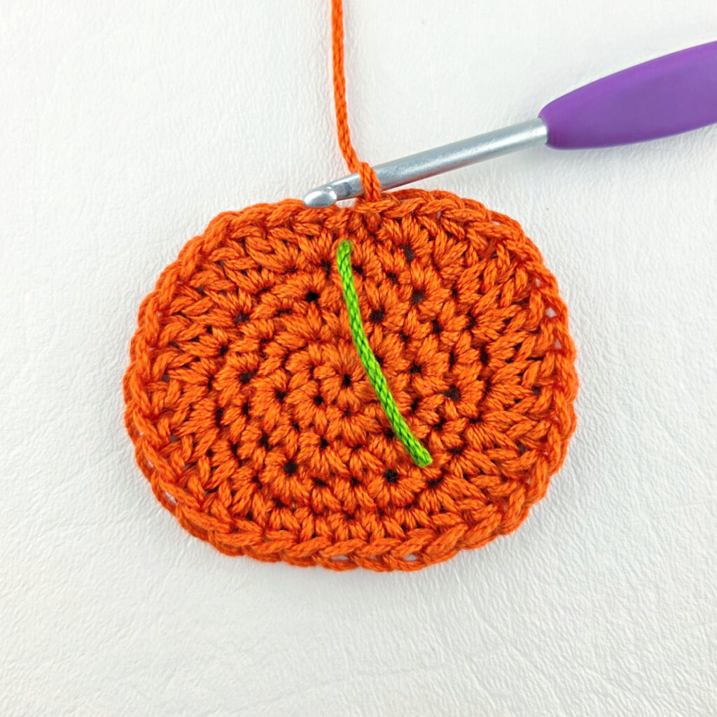 The beginning of a crochet pumpkin applique.