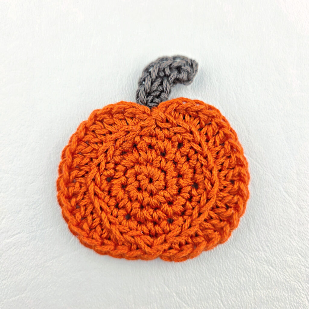 A small crochet pumpkin applique.